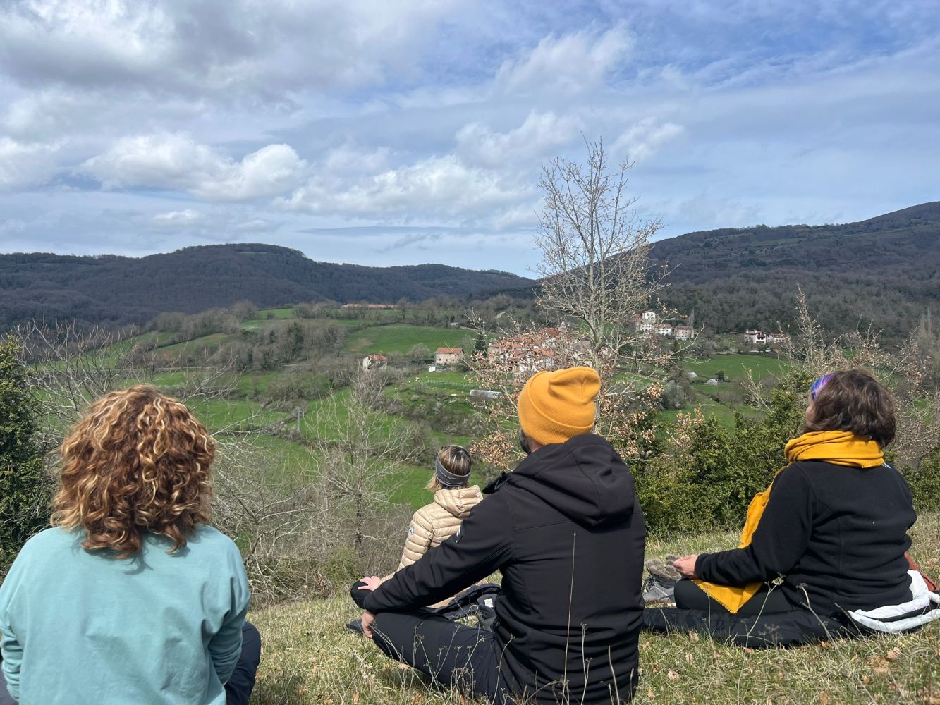 a group of people sitting in a field